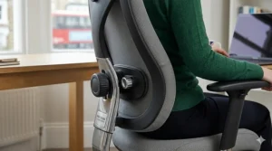 Close-up of an adjustable lumbar support system on a swivel chair to alleviate lower back pain for those with fibromyalgia.