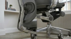 Macro photograph of the multi-directional adjustment paddles and etched icons on a designer office chair.