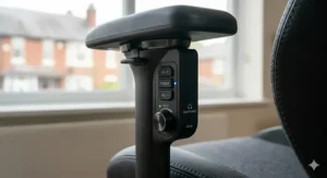 Detail of the side-mounted control panel for adjusting volume, bass, and headphone ports on a professional gaming chair.