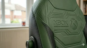 A photorealistic 4K image showing an extreme close-up of the specific green debossed Xbox branding and intricate textures of the ergonomic gaming chair in natural UK daylight.
