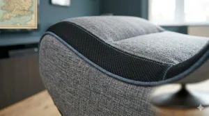 A photorealistic close-up illustration of a grey floor gaming chair, focusing on the breathable mesh material and detailed stitching on the curved side profile.