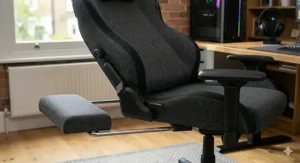 Close-up of a reclining gaming chair showing the telescopic footrest and integrated ergonomic lumbar support.