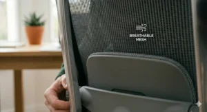 Detail of the breathable grey mesh fabric on an ergonomic backrest for temperature regulation.