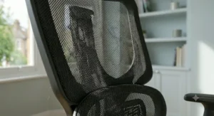 Close-up of breathable fabric on an office chair for coccyx pain comfort.