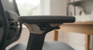 Detailed view of multi-directional 4D armrests to suit different desk heights and typing styles.