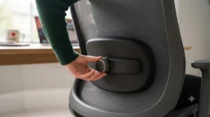 Close-up of an adjustable lumbar support feature on an office chair for pregnancy back pain.
