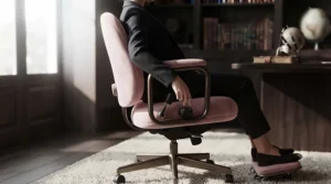 Person sitting comfortably with correct posture in a supportive petite office chair.