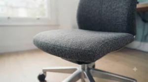 Modern grey fabric office chair featuring a high-back design with adjustable headrest.