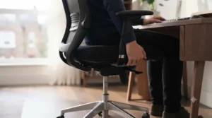 A fully adjustable office chair showing the pneumatic height lift and flip-up armrest range.