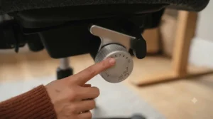 Close-up of a gas lift lever showing a low minimum seat height adjustment for shorter users.