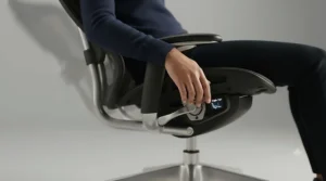 A detailed close-up of the ergonomic tilt lock mechanism on the side of the modern office chair, showing the polished silver lever and geared cam system.