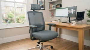 A comfortable, wide-seat task chair positioned at a minimalist wooden desk in a contemporary British apartment.